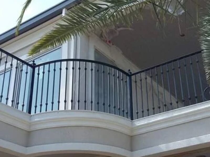 Dark metal railing following the curve of a balcony