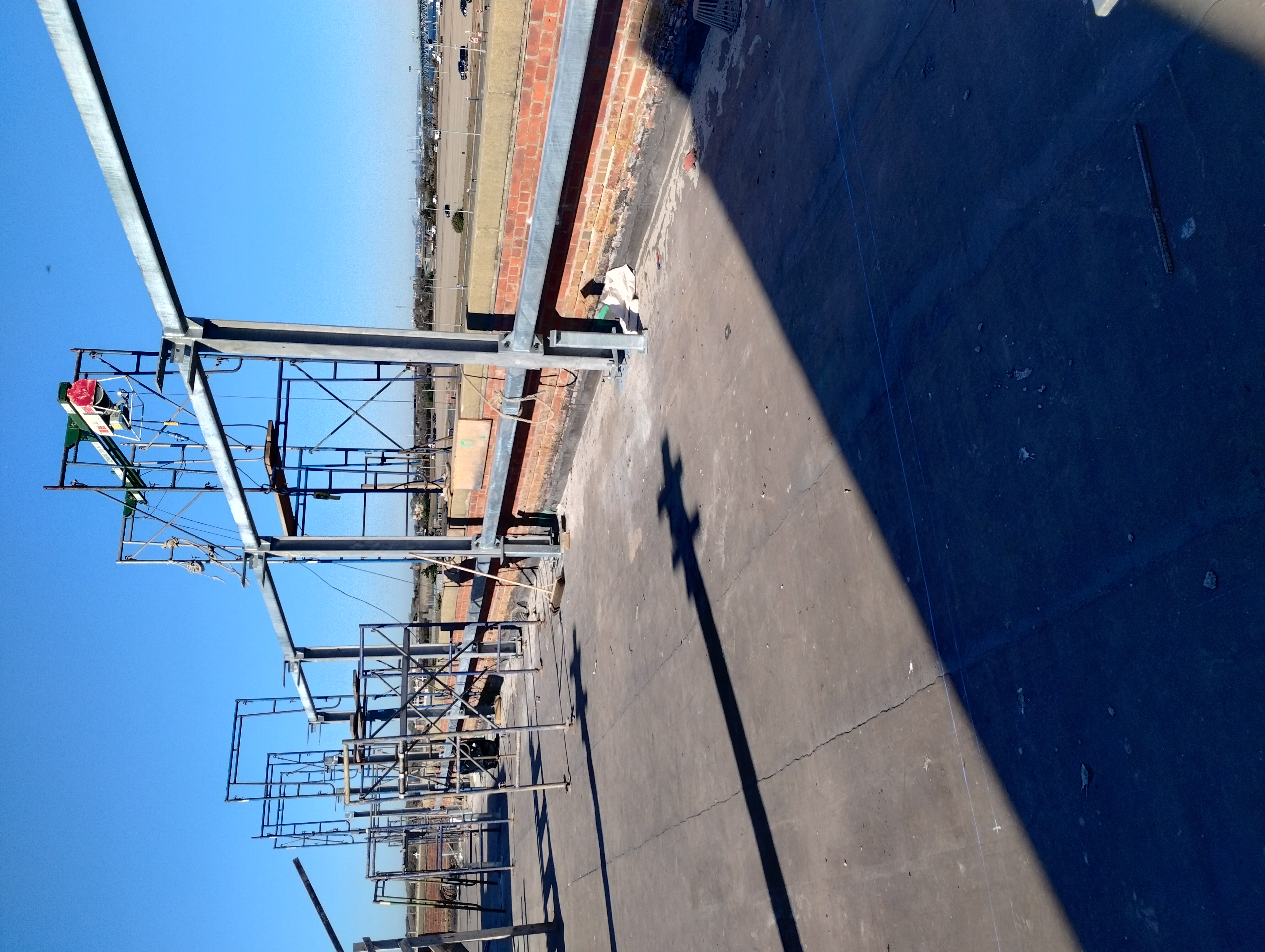 Steel posts and horizontal members installed along a rooftop parapet