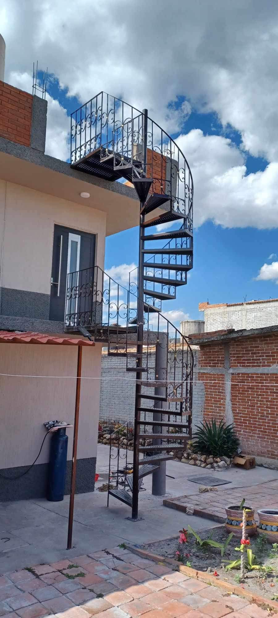 Exterior spiral steel staircase with decorative scrollwork railings
