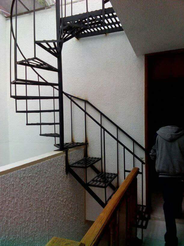 Black steel spiral staircase with simple vertical railings
