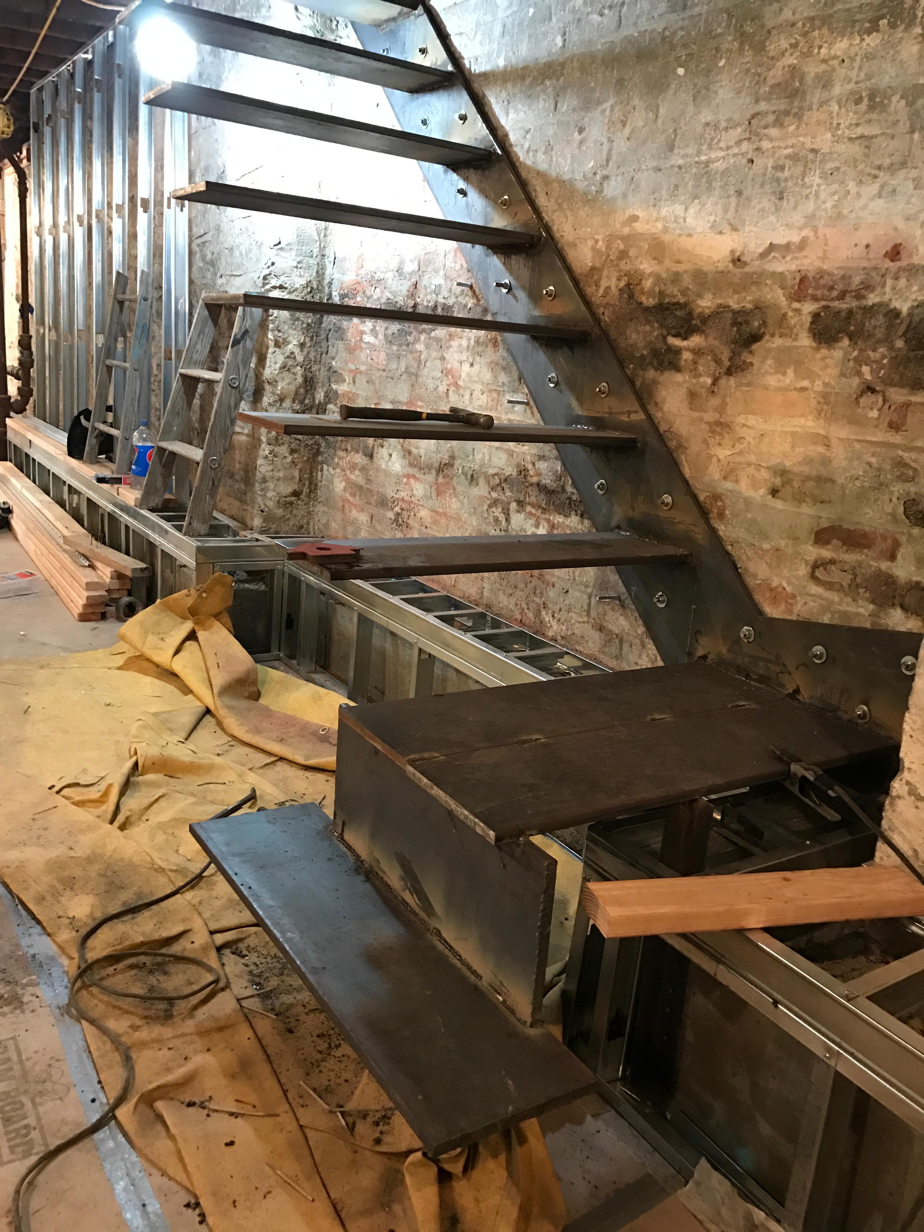 Steel stair assembly and lower turning steps during interior installation