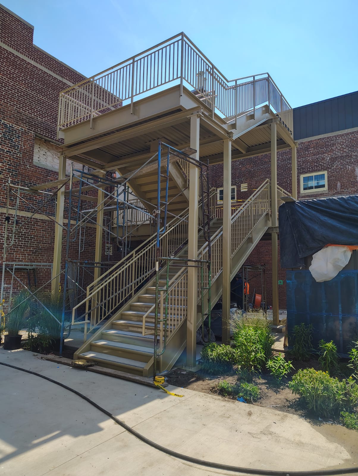 Exterior steel staircase with an elevated platform and railings