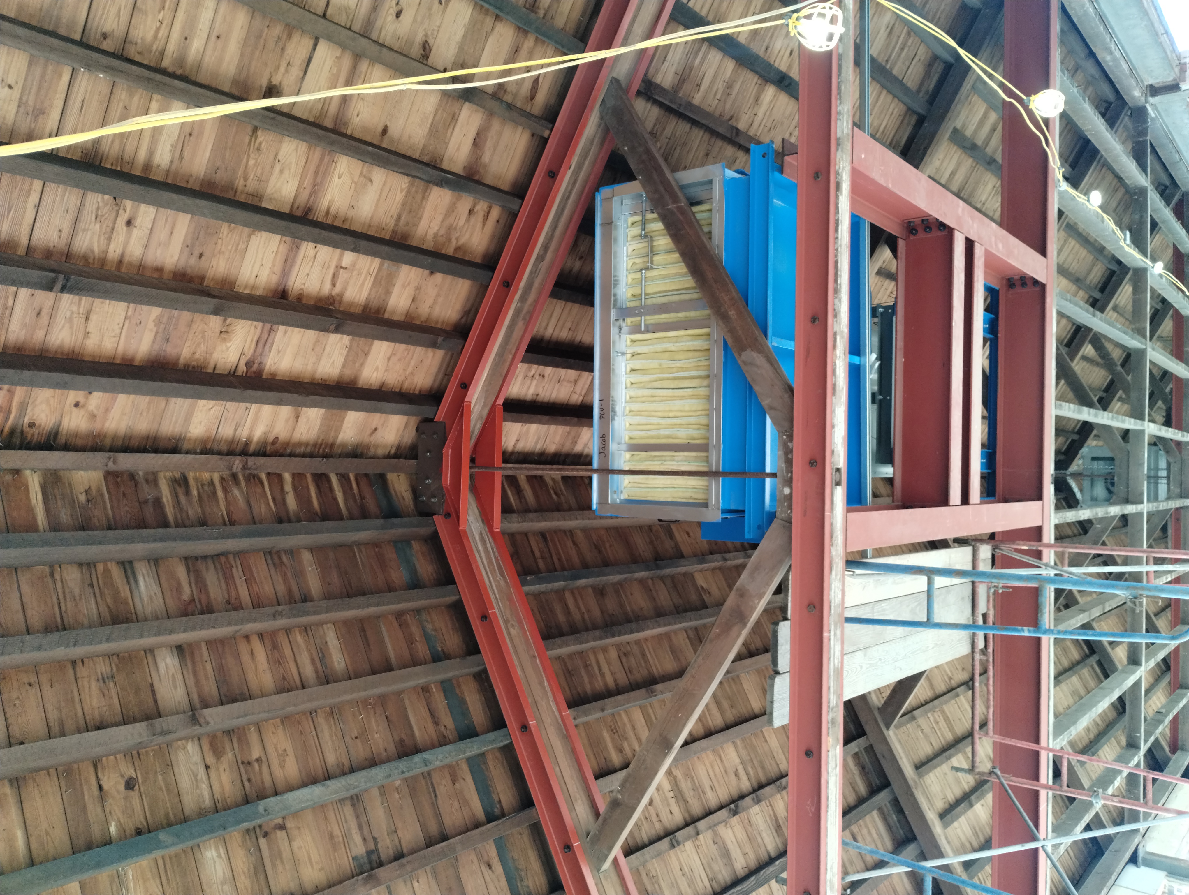 Steel reinforcement and bolted connections alongside a timber roof truss