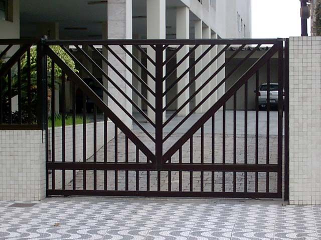 Black steel driveway gate with a geometric chevron pattern