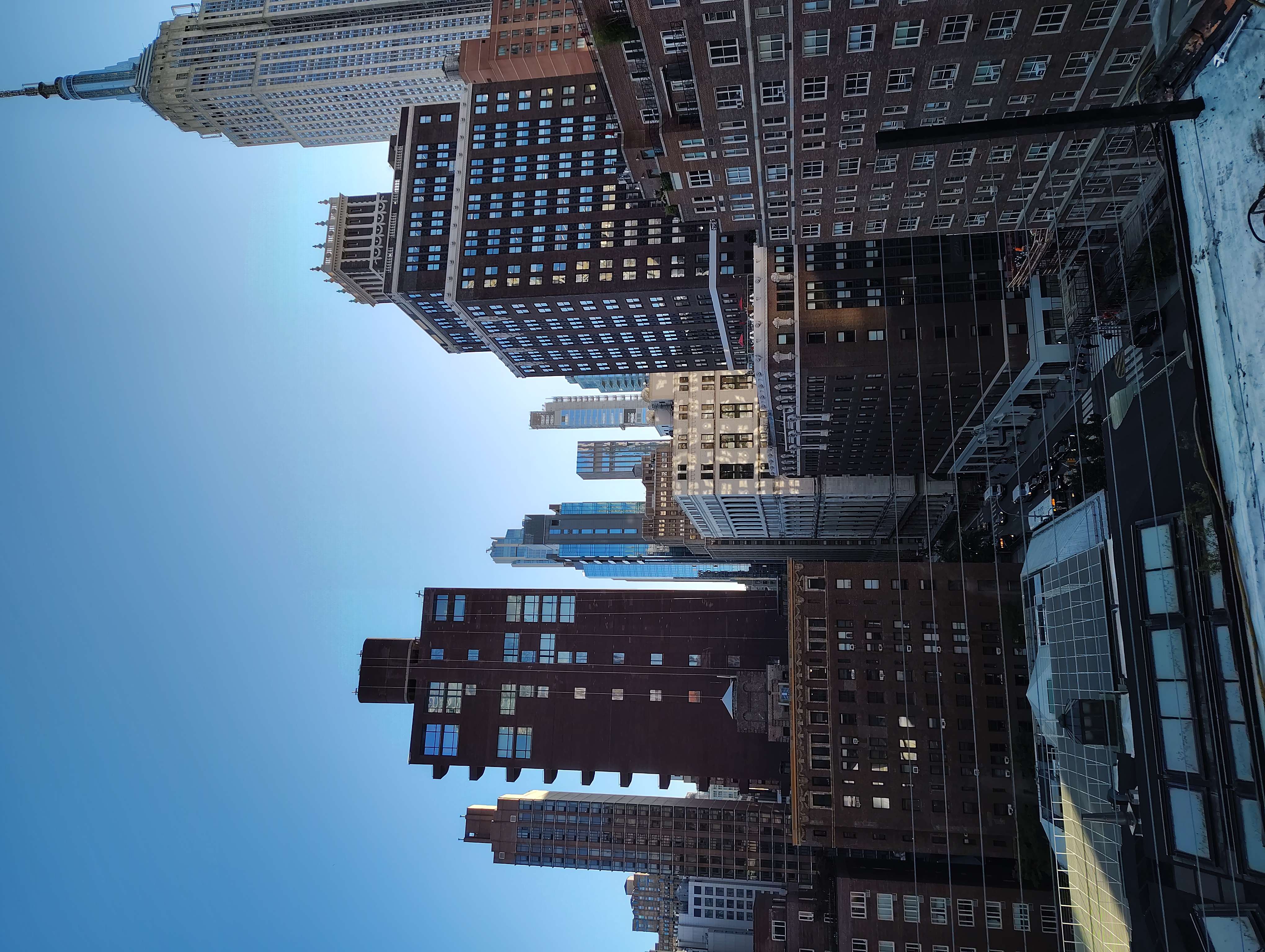 Manhattan skyline viewed across rooftop cable railings