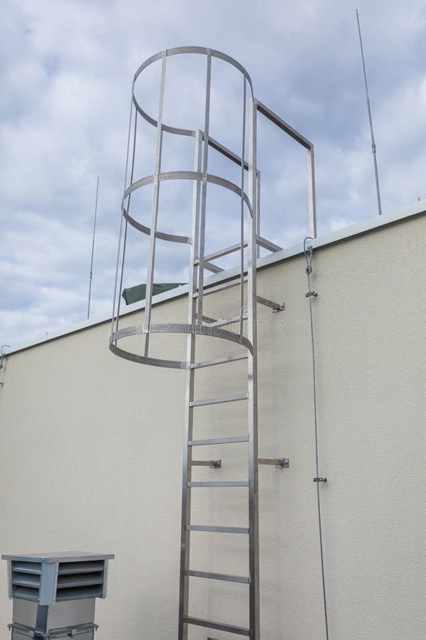 Wall-mounted roof access ladder with a metal cage; supplied reference image