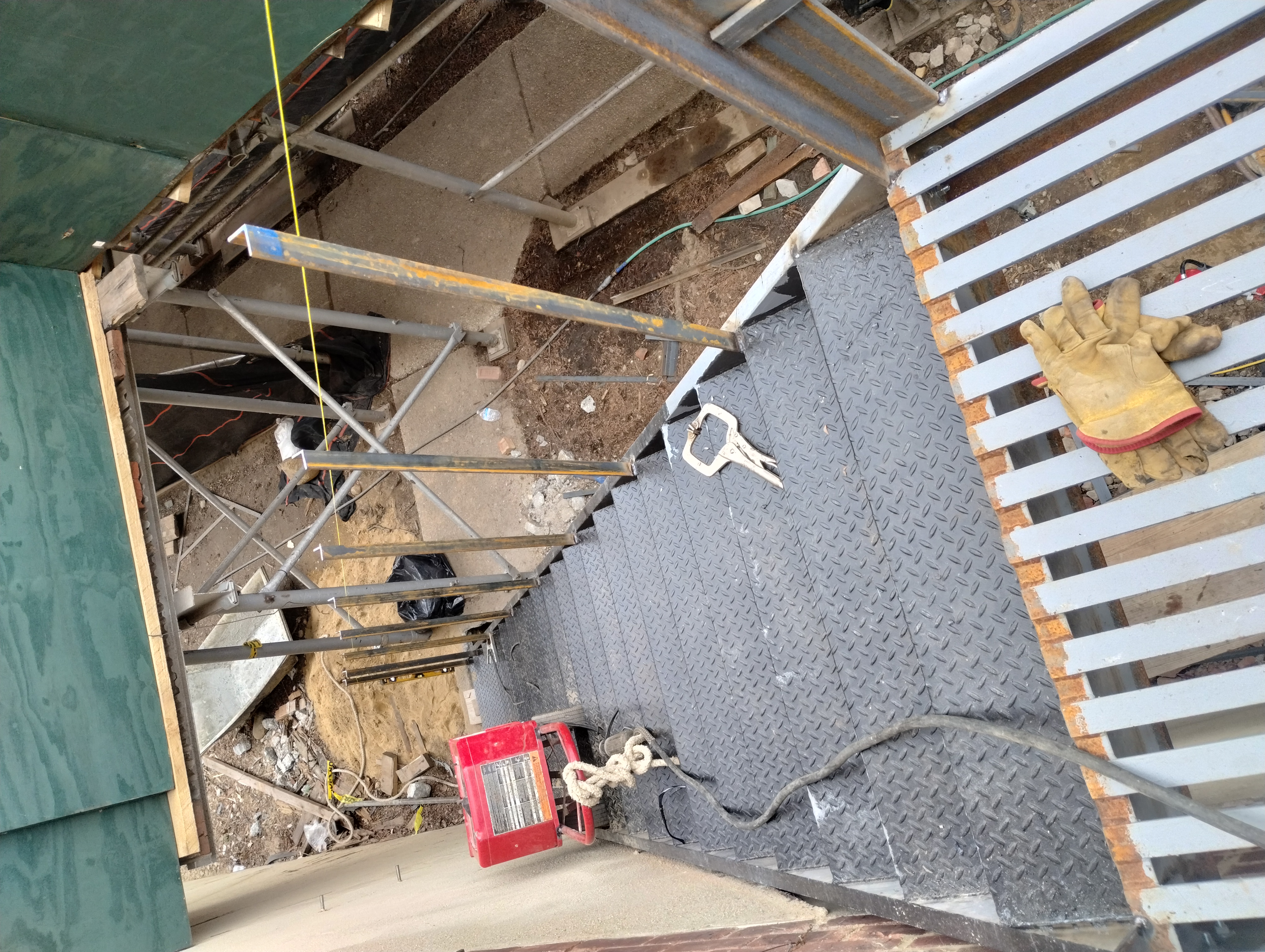 Steel stair treads and railing posts during assembly