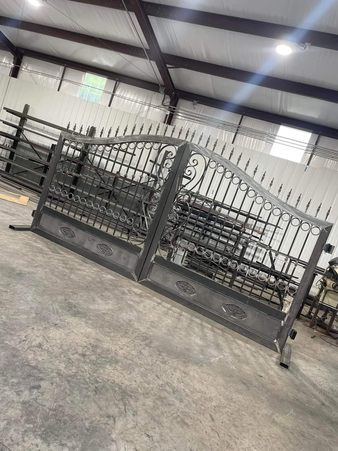 Steel gates in the workshop, with curved tops and decorative scrollwork