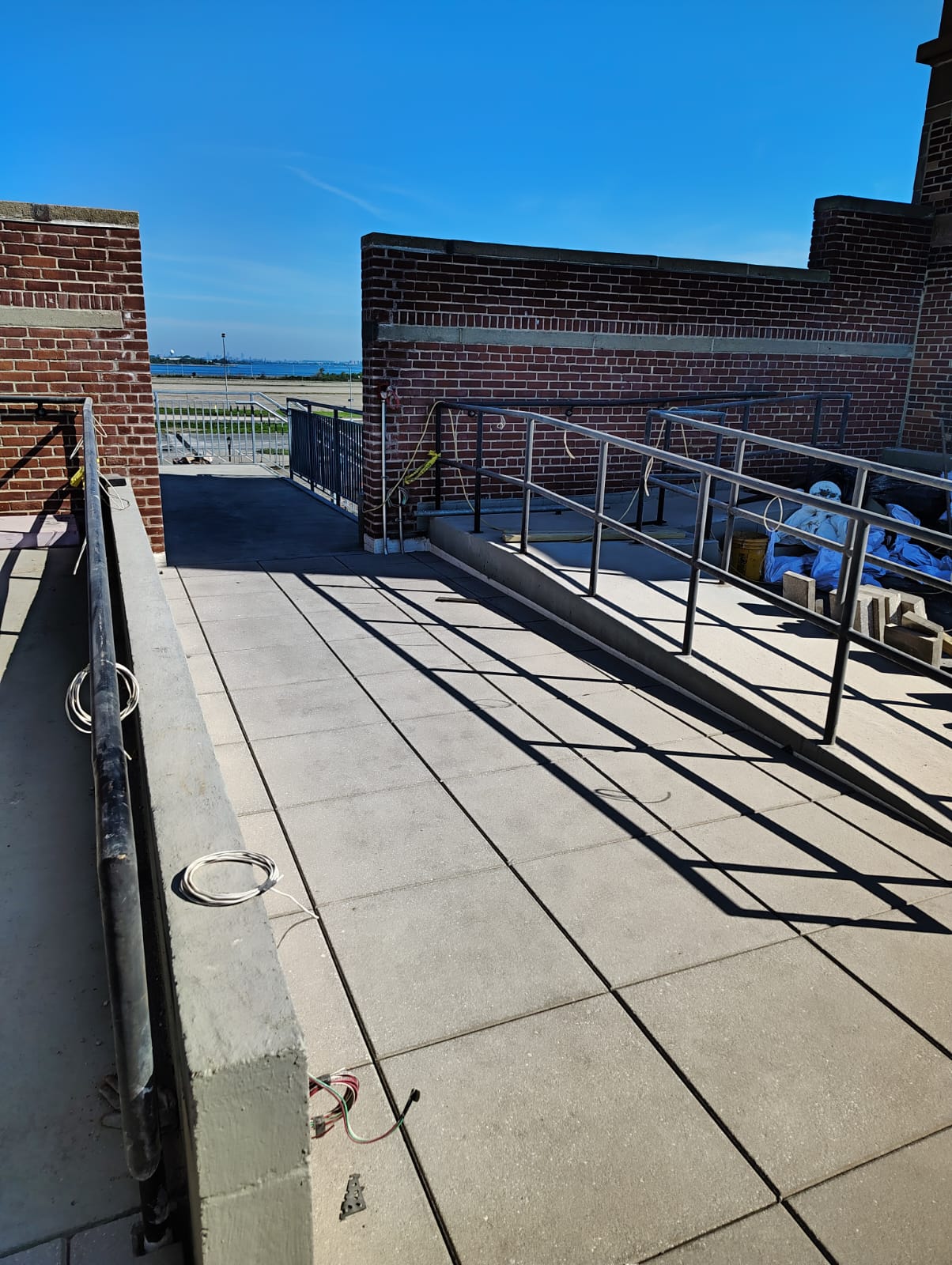 Metal handrails lining rooftop ramps and walkways during installation