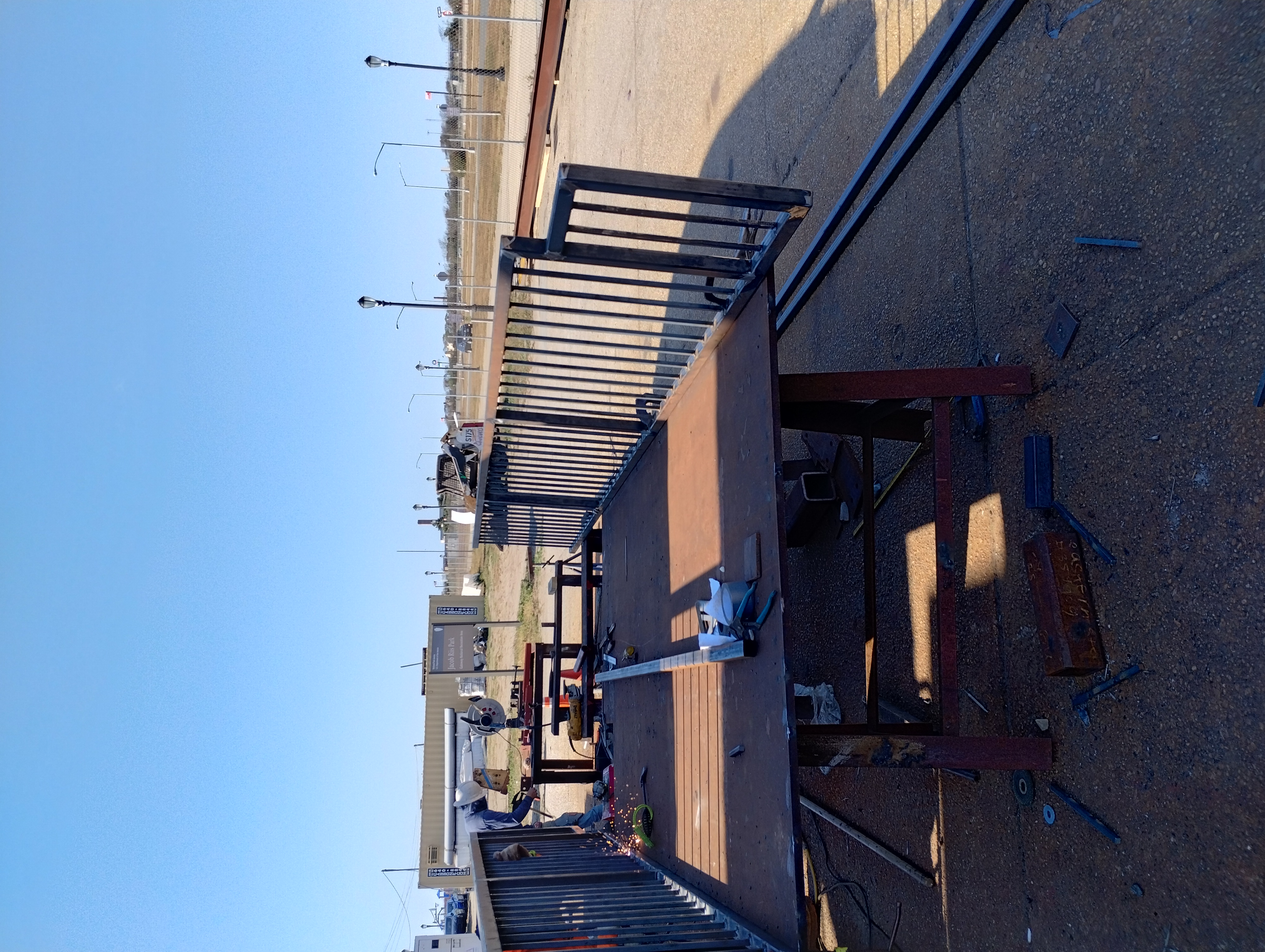 Steel railing panels being assembled on an outdoor fabrication table