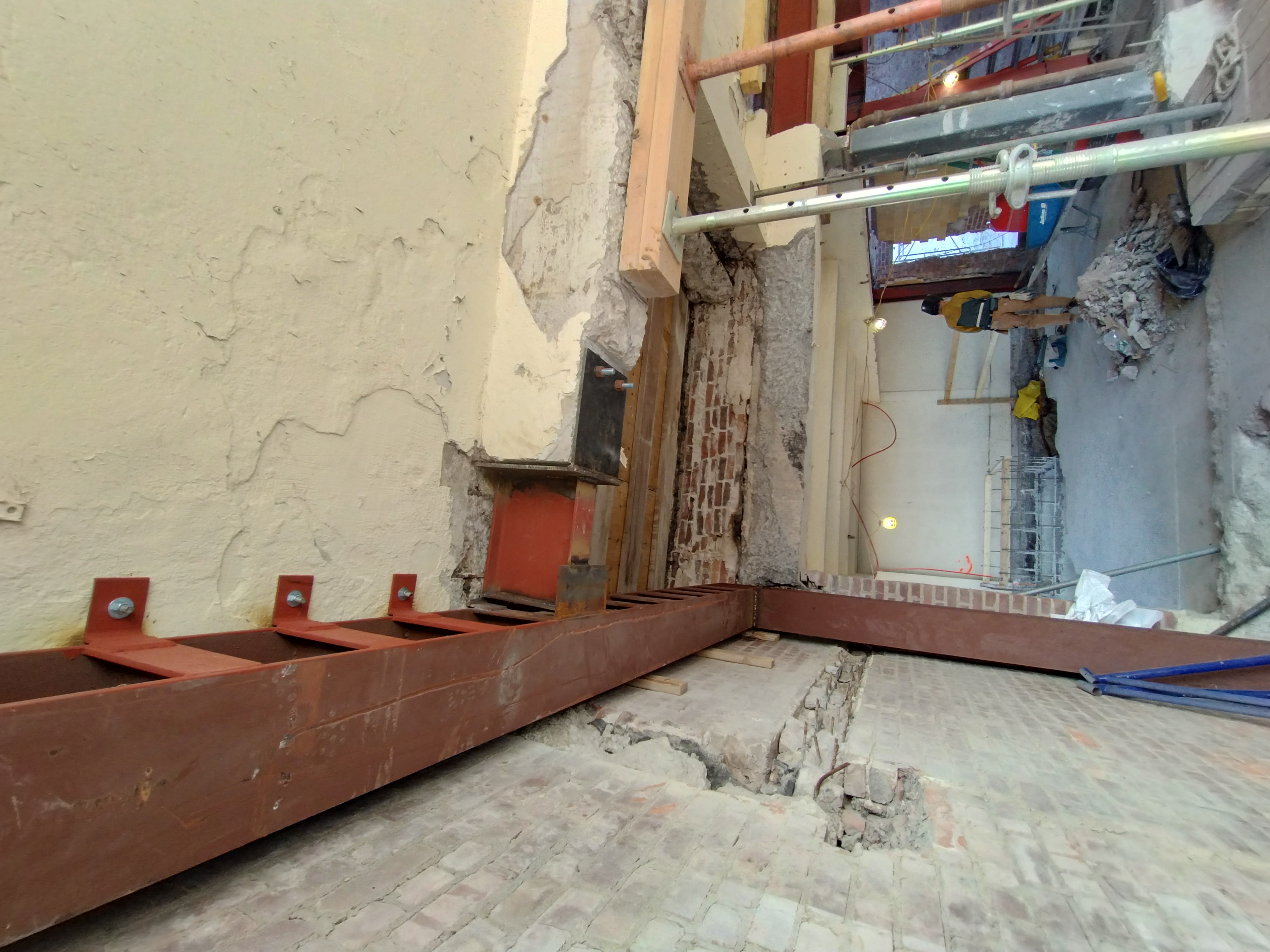 Steel beams and connections installed within an existing masonry building