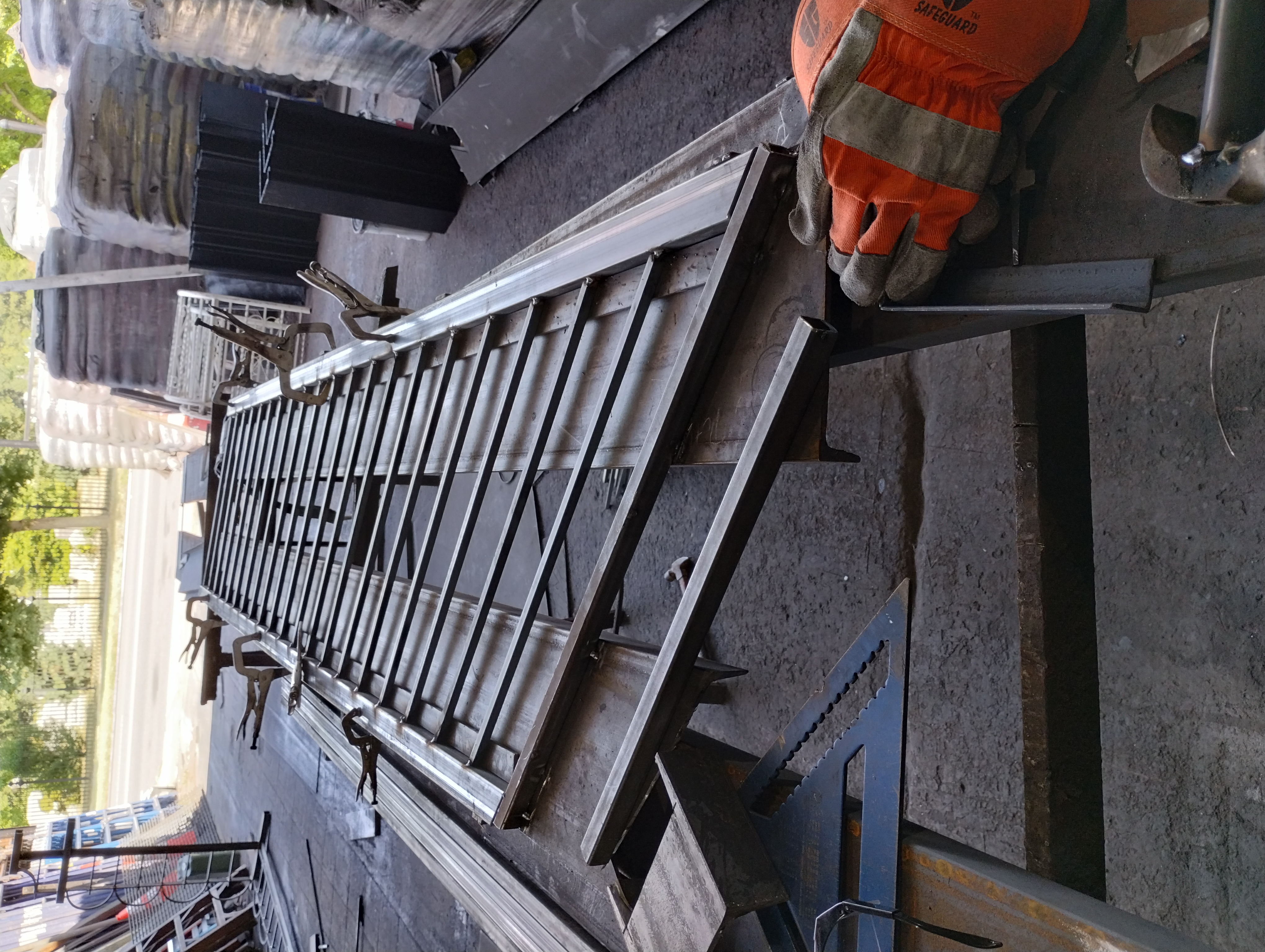 Steel railing section clamped on a fabrication table