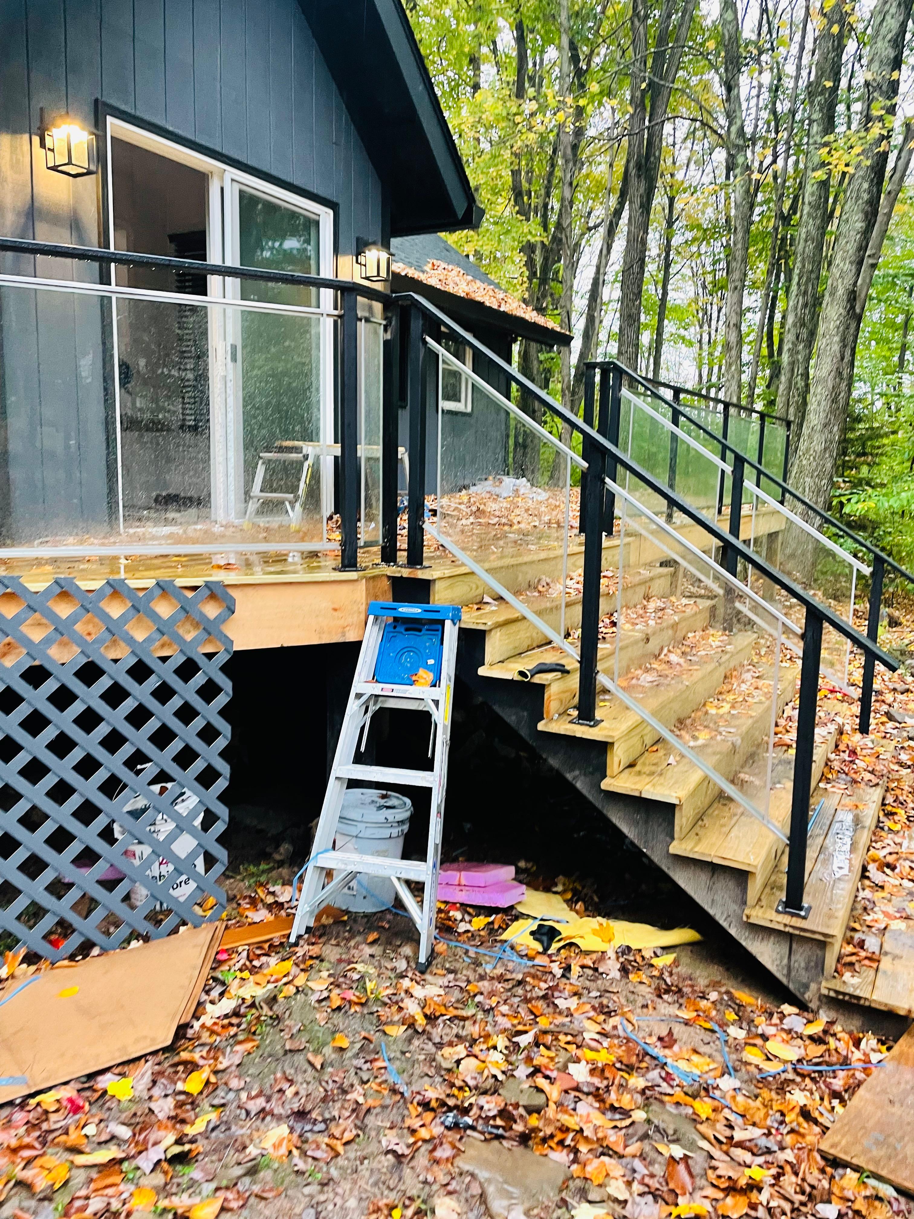 Glass panels and black metal railings beside exterior stairs