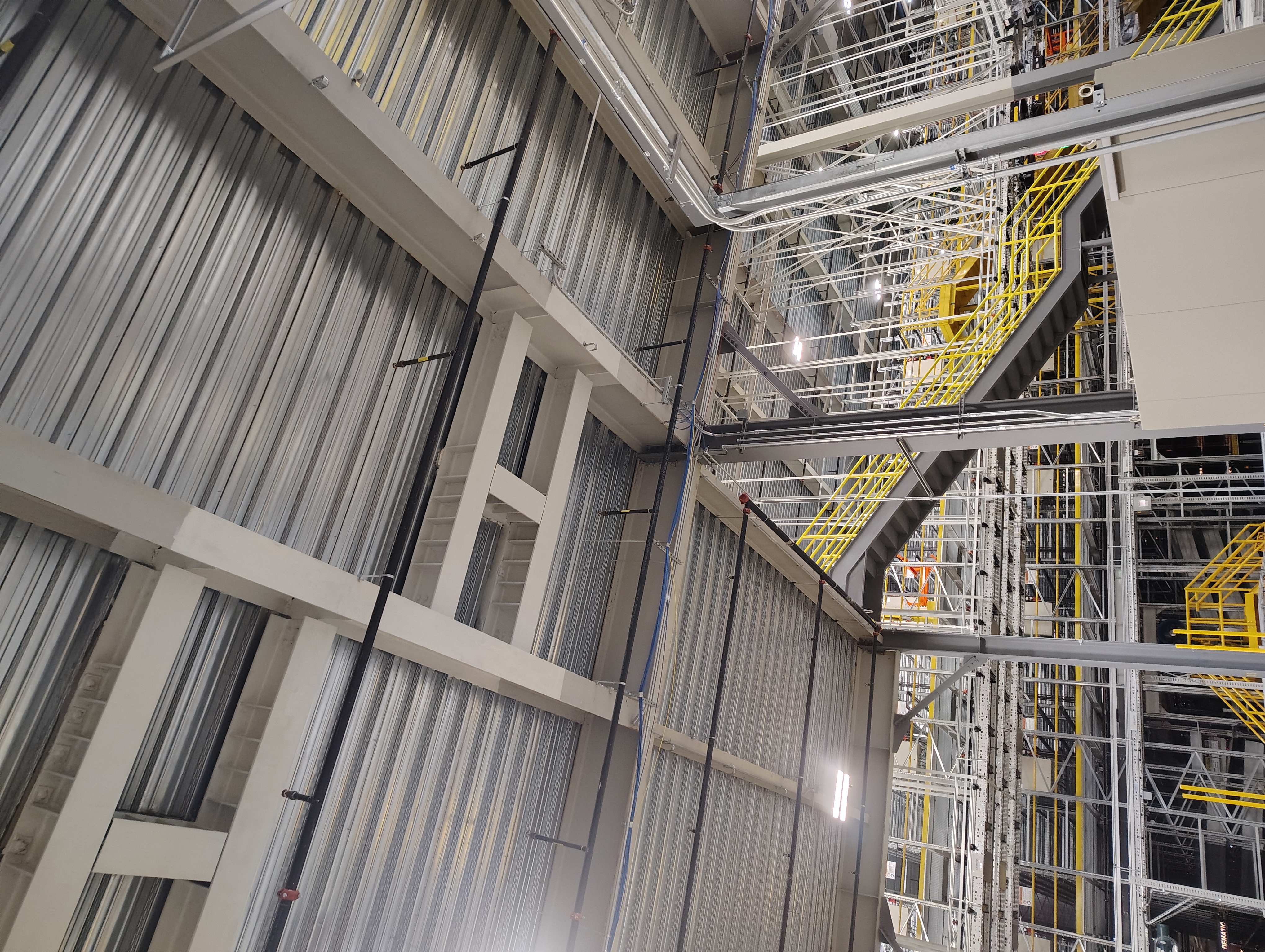 White steel reinforcement framing beneath industrial metal decking