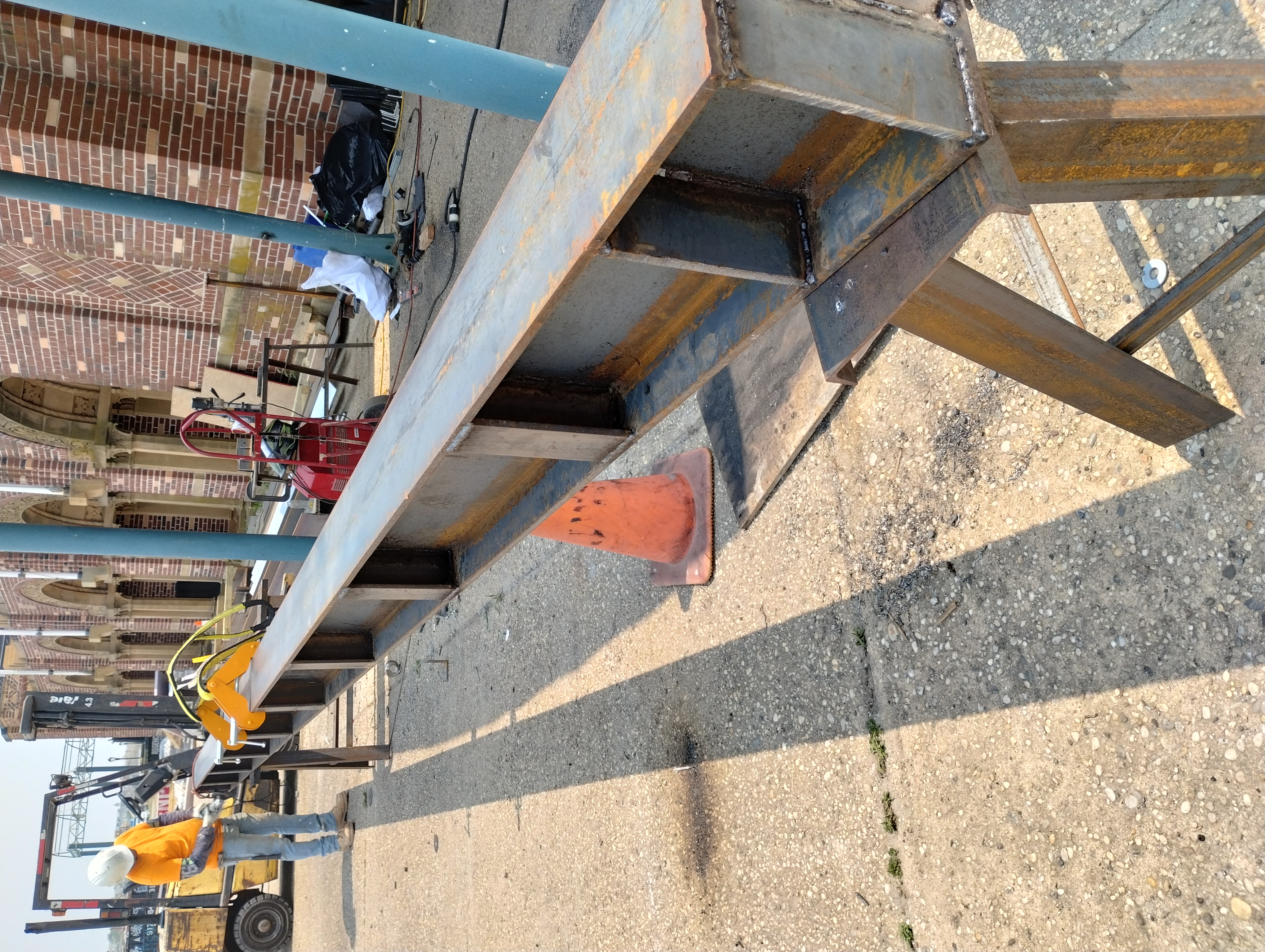 Long steel beam with welded stiffener plates supported in an outdoor work area