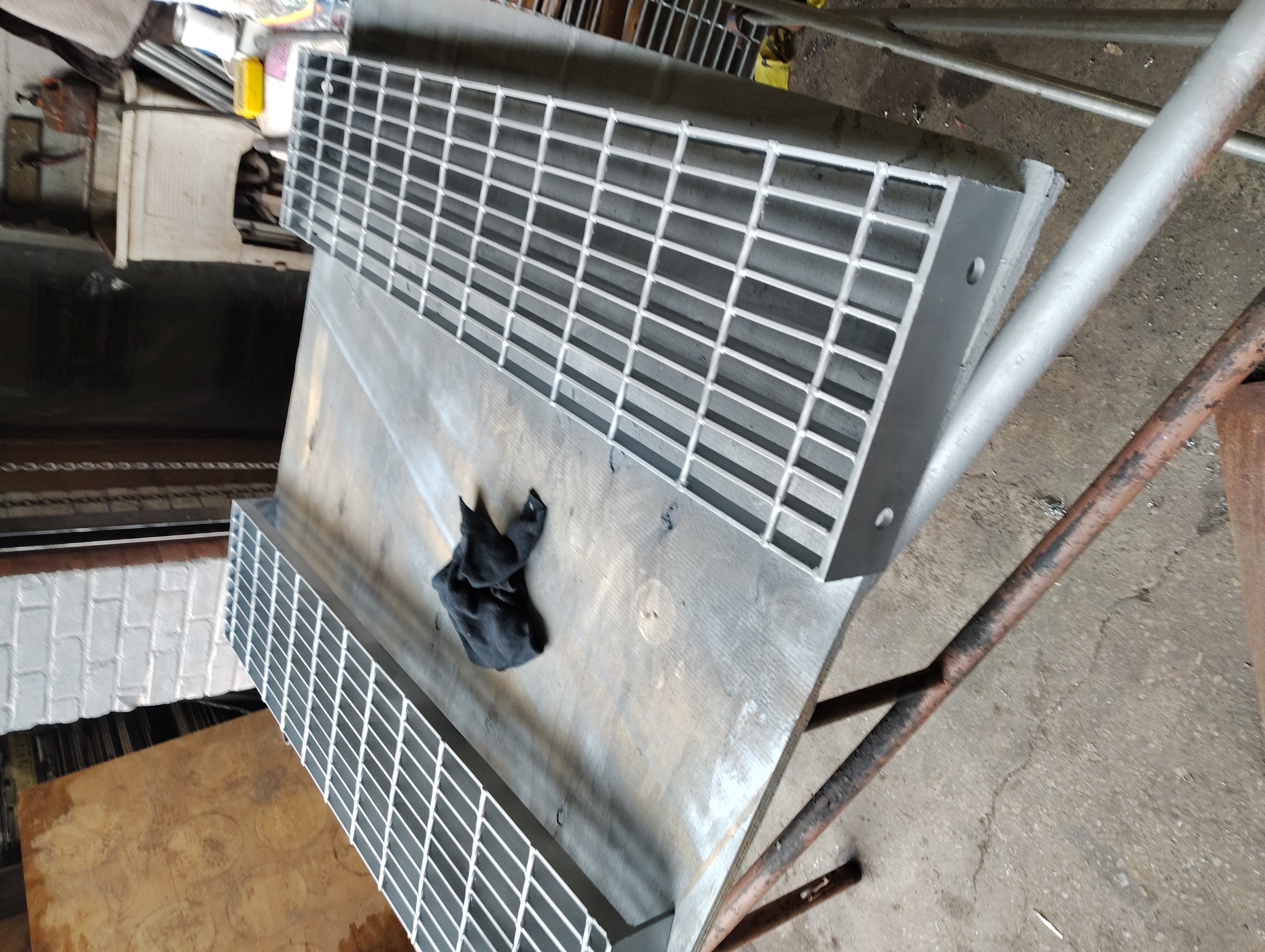 Coated steel grating stair treads on a workshop table