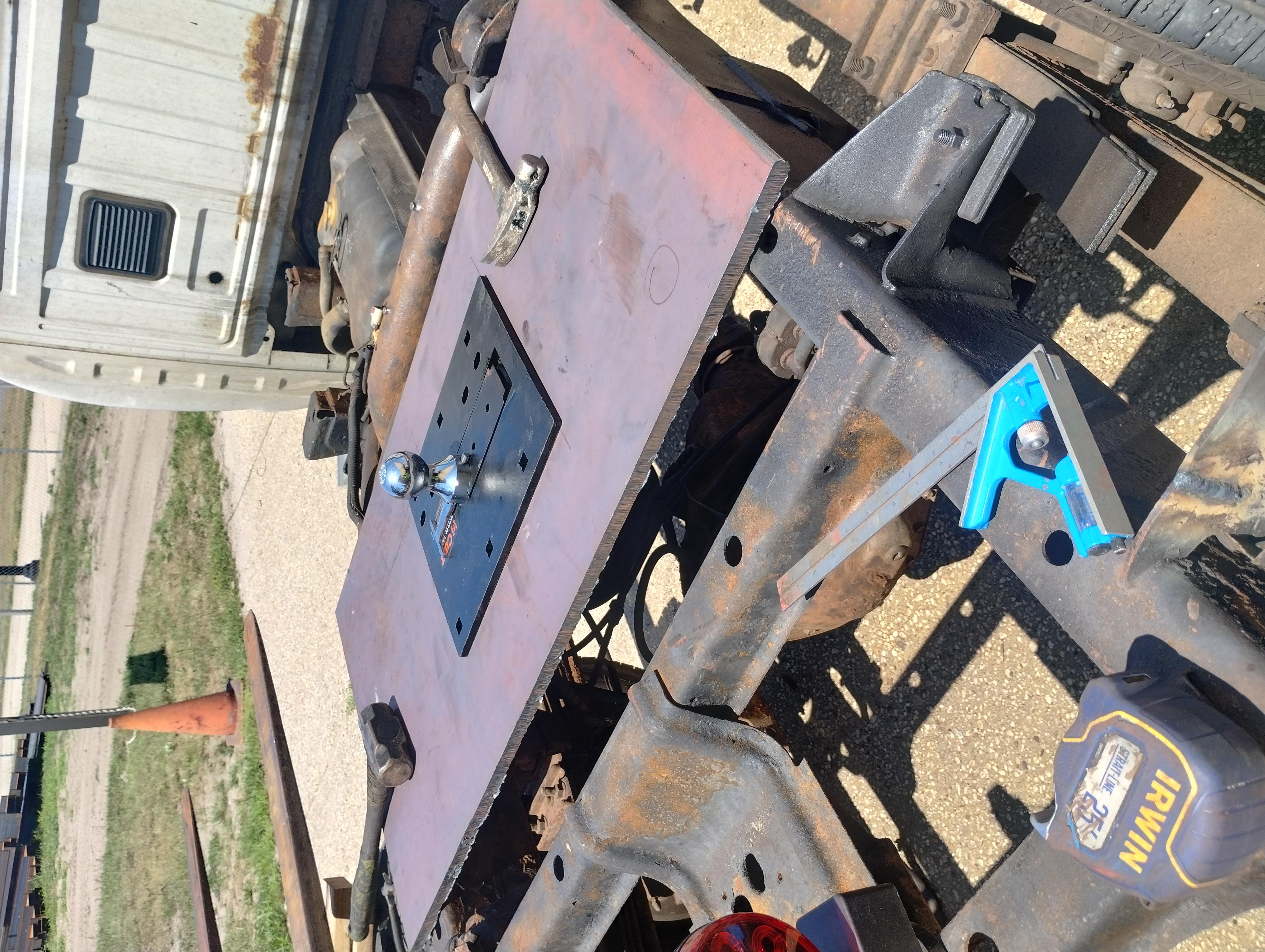 Steel plate and hitch assembly positioned on a vehicle frame